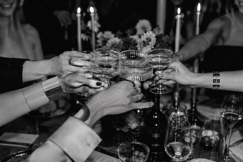 Guests toasting with champagne at a dinner table