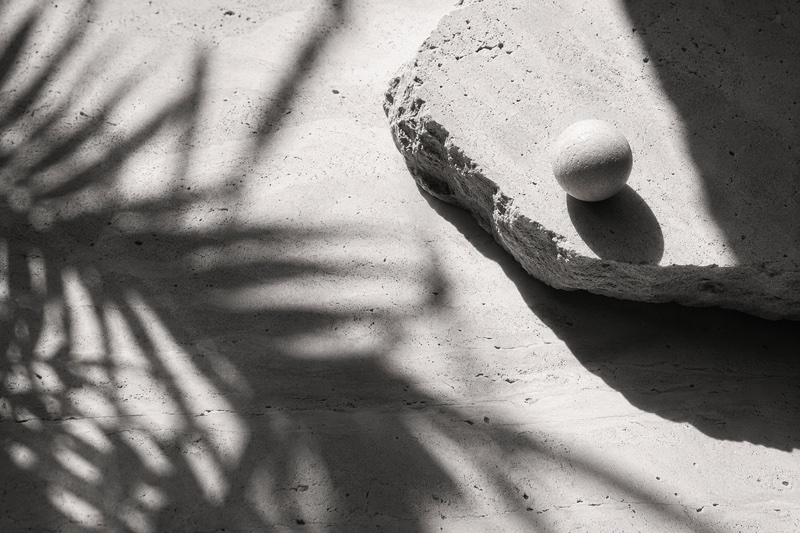 Stone surface with salt sphere and palm shadows